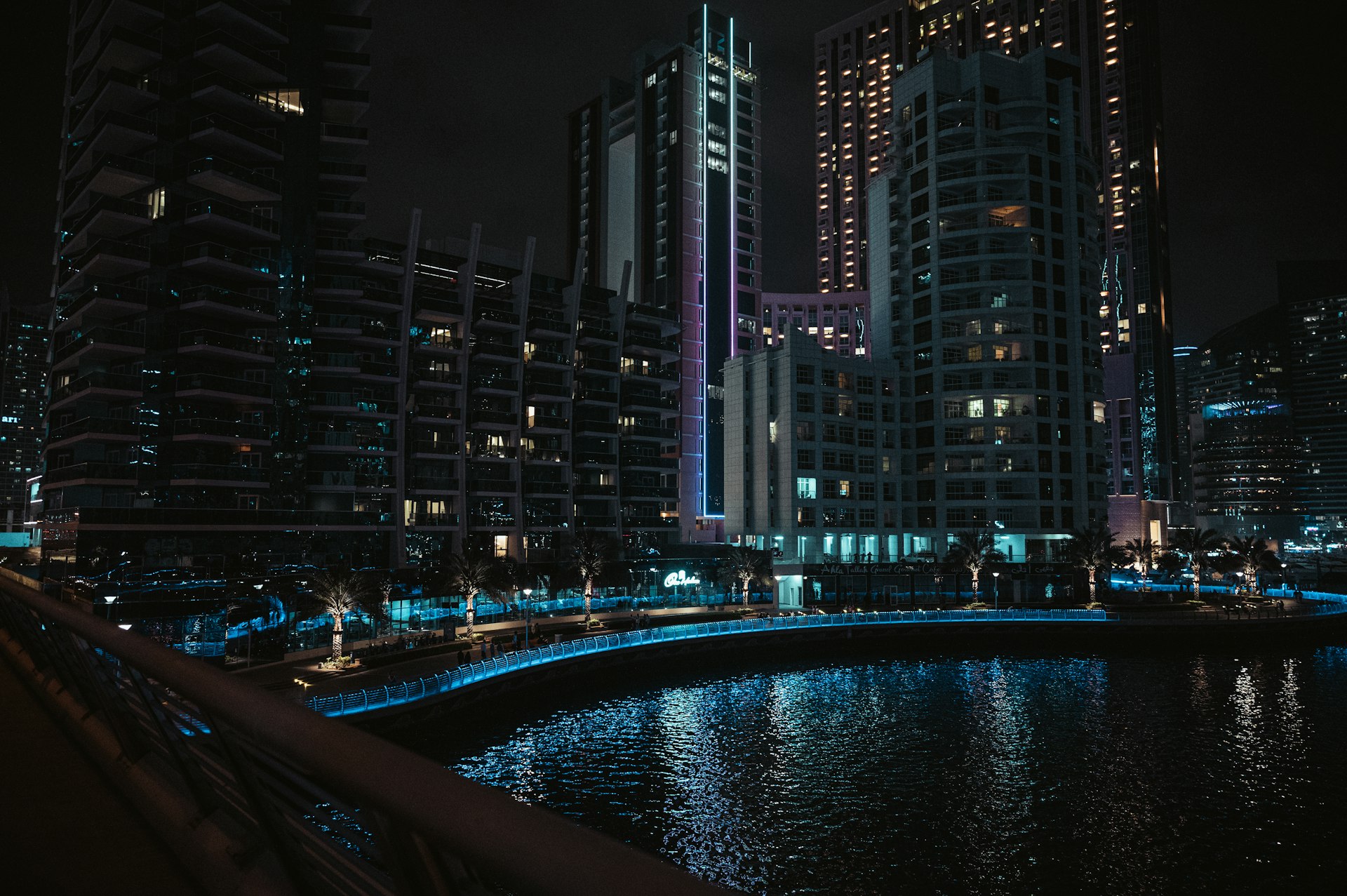 a city at night with a river running through it